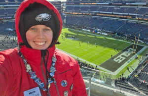 Marie Graney, pastoral services coordinator at St. Ann’s, Wilmington, helps you to your seat at Lincoln Financial Field