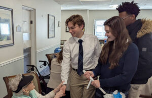 Holy Cross High School Students share holiday spirit at Brookdale Senior Living in Dover