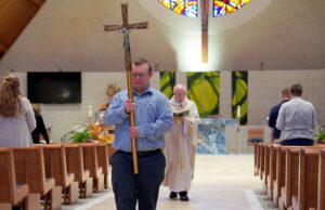 With reverence, contagious smile, volunteer Robby Heil with Down syndrome inspires Michigan parish