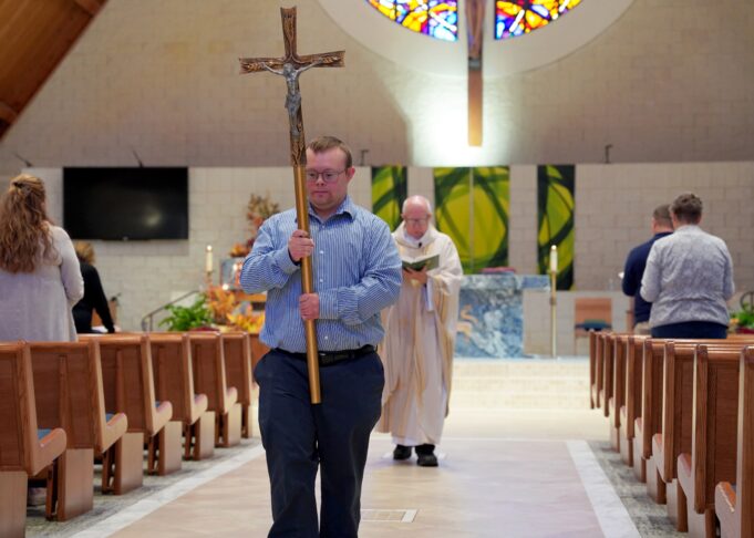 With reverence, contagious smile, volunteer Robby Heil with Down syndrome inspires Michigan parish