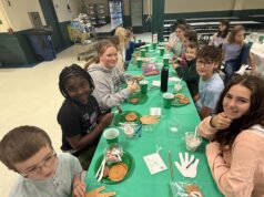 Holy Cross elementary students welcome people new to the school with parfait and yogurt bar, faith-centered activity