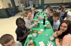 Holy Cross elementary students welcome people new to the school with parfait and yogurt bar, faith-centered activity