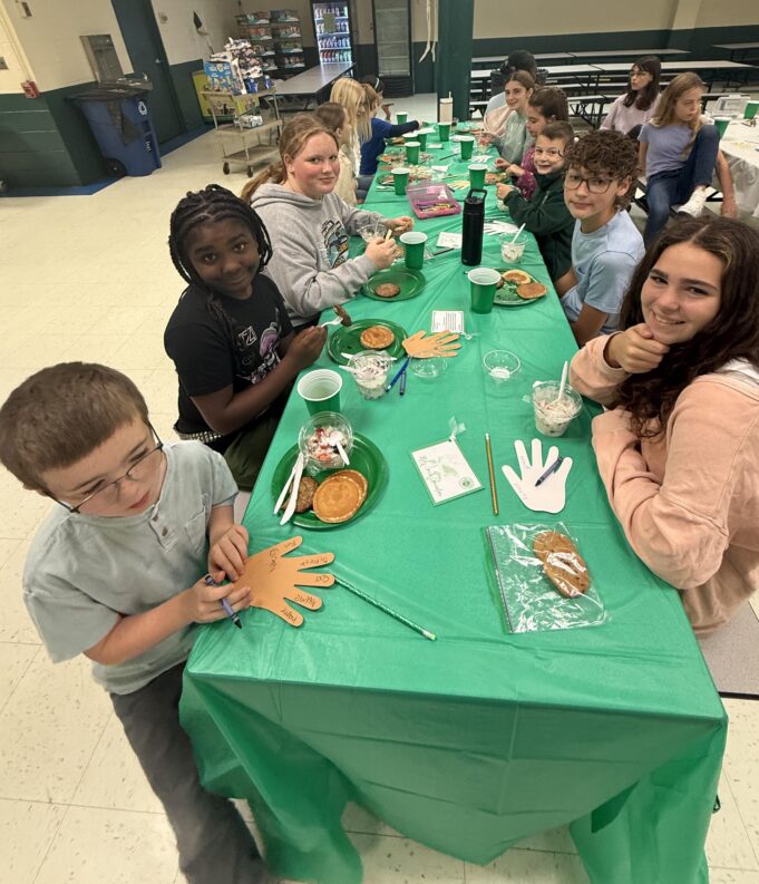 Holy Cross elementary students welcome people new to the school with parfait and yogurt bar, faith-centered activity